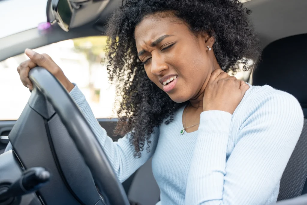A driver holding her neck after a collision in Tolland